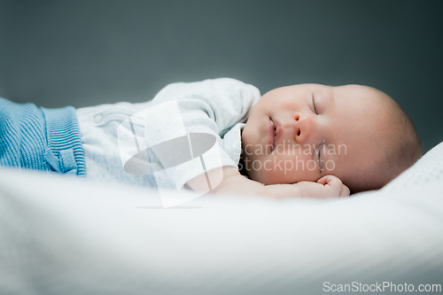 Image of Close-up portrait of adorable baby boy sleeping in bed, 1 year old baby concept