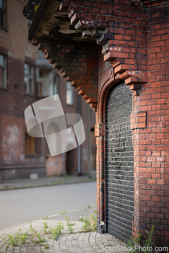 Image of A bricked up entrance to a brick building