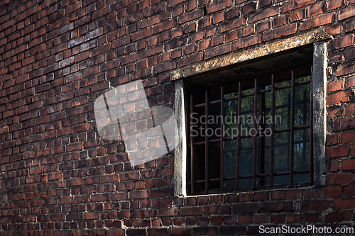 Image of A barred window in a brick wall