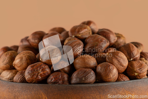 Image of Hazelnuts in a wooden bowl close-up