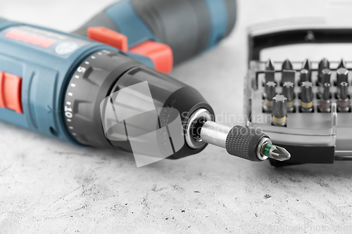 Image of Professional cordless drill screwdriver and screwdriver bit set close-up