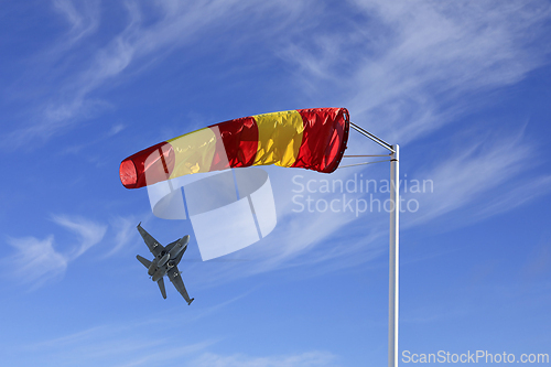 Image of Striped Windsock With Jet Taking Off 