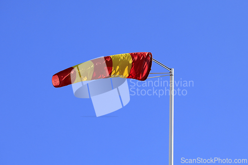 Image of Striped Windsock against Clear Blue Sky