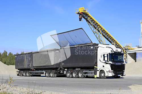 Image of Truck Driver Closing Trailer Roof after Loading