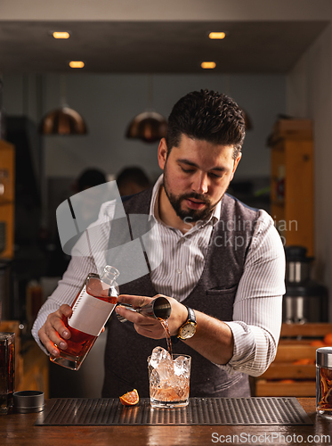 Image of Bartender pouring a craft cocktail at the bar