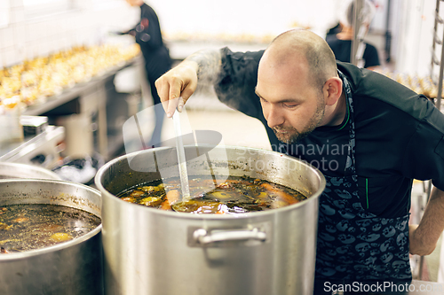 Image of Professional chef carefully tasting