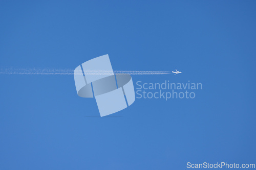 Image of airplane on blue sky background