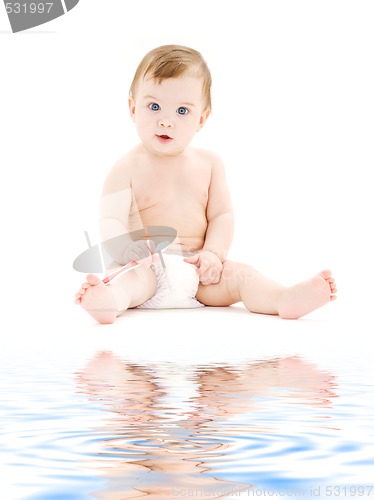 Image of baby boy in diaper with toothbrush