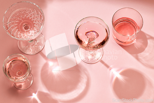 Image of various glasses on pink background