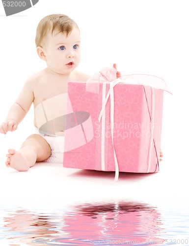 Image of baby boy in diaper with big gift box