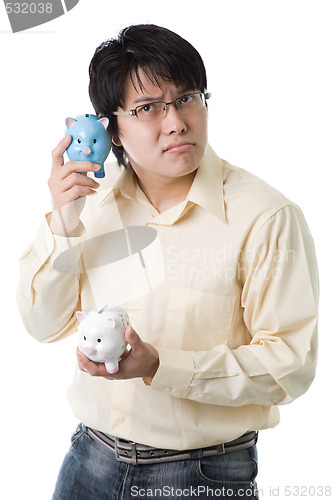 Image of Asian businessman with piggy banks