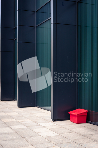 Image of A red box next to a modern building