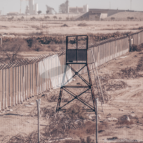 Image of Fenced borderline, barbed wires and watchtower. Non-passable military zone