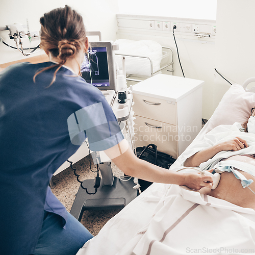 Image of Prenatal medical exam. Female doctor using ultrasound scanner for gynecologist telling and showing patient embryo. Fertility pregnancy ovulation concept.