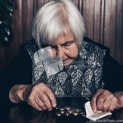 Image of Portrait of an old woman counting money. The concept of old age, poverty, austerity.