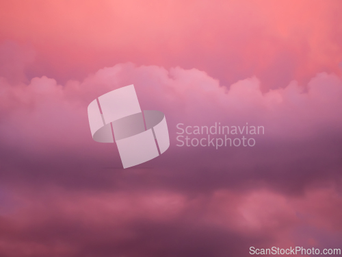 Image of Detail of redish and violet clouds on evening sky
