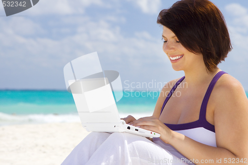 Image of woman with laptop computer on the beach