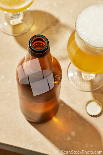 Image of bottle and glasses of beer