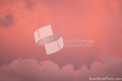 Image of Detail of redish and violet cloudscape pattern on evening sky