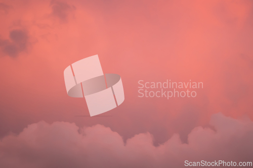 Image of Detail of redish and violet cloudscape pattern on evening sky