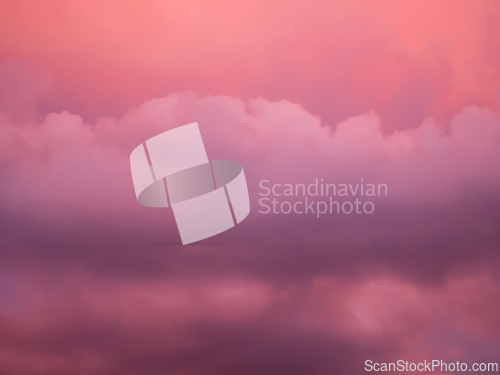 Image of Detail of redish and violet clouds on evening sky