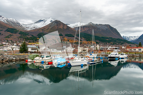 Image of Tranquil harbor in Norway showcasing anchored boats reflecting m