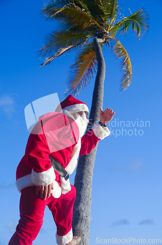 Image of Santa Claus is on vacation on a tropical beach.