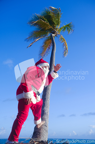 Image of Santa Claus is on vacation on a tropical beach.