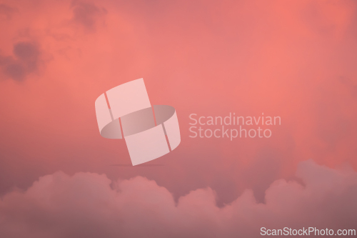 Image of Detail of redish and violet cloudscape pattern on evening sky