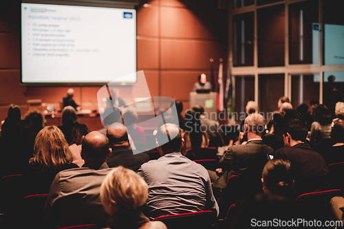 Image of Audience in lecture hall participating at business event.
