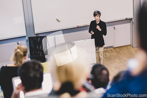 Image of Speaker giving presentation in lecture hall at university.