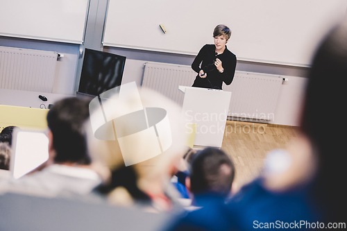 Image of Speaker giving presentation in lecture hall at university.