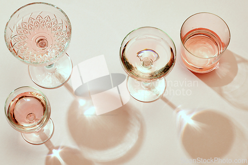 Image of various glasses on pink background