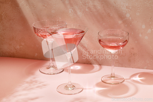 Image of various glasses on pink background