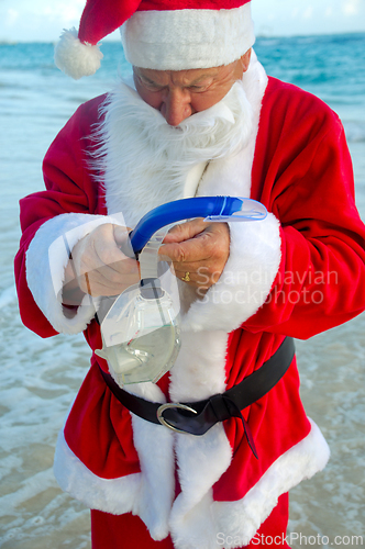 Image of Santa Claus is on vacation on a tropical beach. 