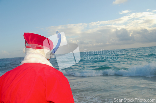 Image of Santa Claus is on vacation on a tropical beach. 
