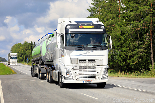Image of Two White Volvo FH Trucks on Road