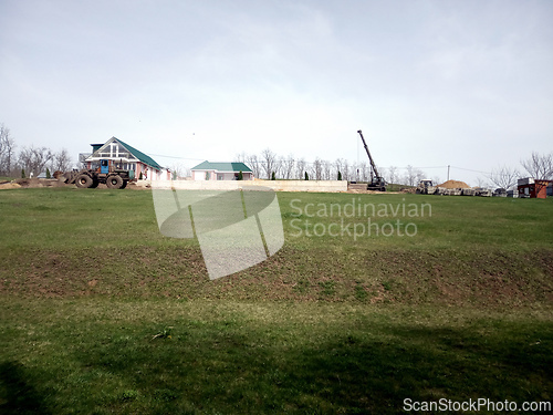 Image of one-story houses car crane excavator