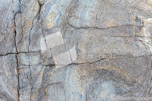 Image of Detailed close-up of textured rock surface displaying natural co