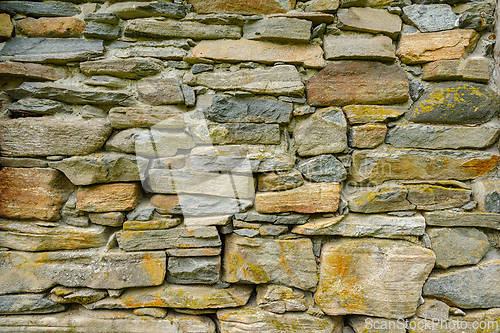 Image of Textured stone wall featuring varied colors and shapes in a natu