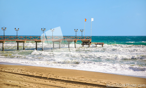 Image of wooden pier on the Costa del Sol in Marbella, Spain
