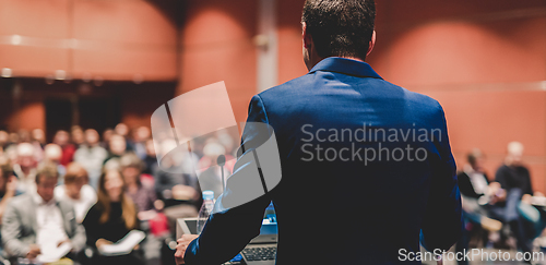 Image of Public speaker giving talk at Business Event.