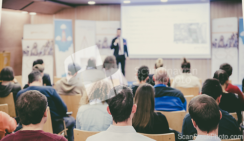 Image of Business speaker giving a talk at business conference event.