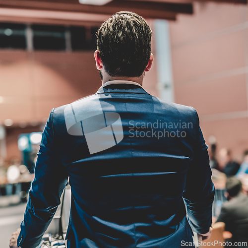Image of Public speaker giving talk at Business Event.