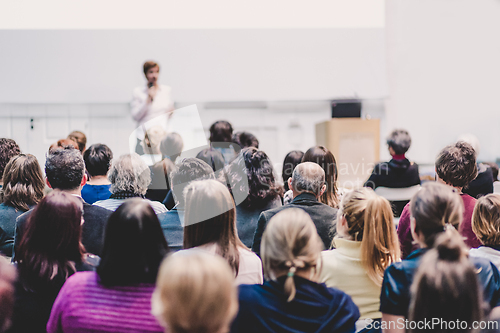 Image of Woman giving presentation on business conference event.