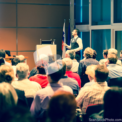 Image of Business speaker giving a talk at business conference meeting event.