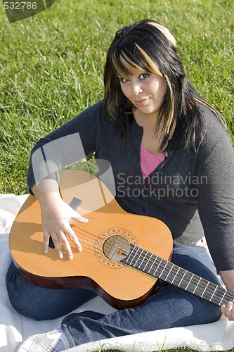 Image of Girl Playing a Guitar