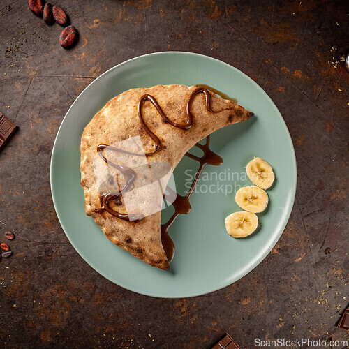 Image of Delicious calzone drizzled with chocolate sauce