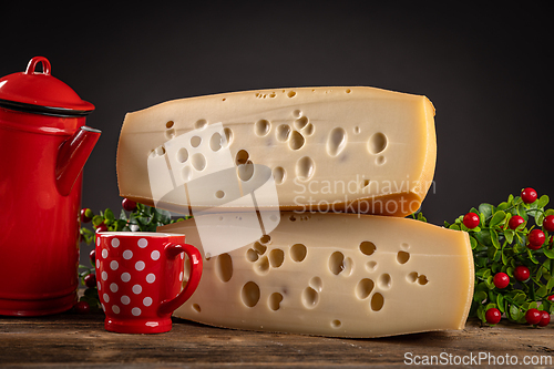 Image of Two blocks of swiss cheese on wooden table