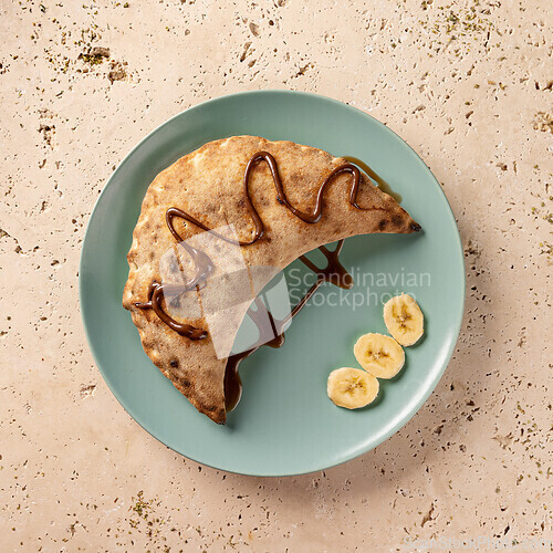 Image of Calzone with chocolate sauce and banana slices